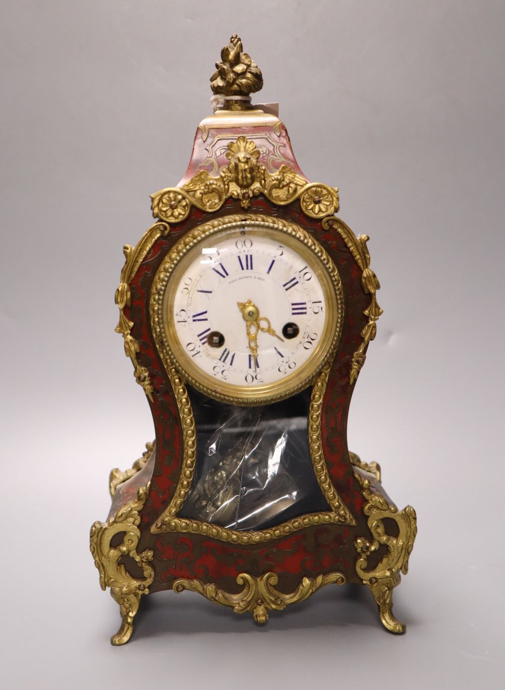 A 19th century French boullework and ormolu mounted mantel clock, dial signed by retailer Thos. Pearce and Sons, Paris, 31cm